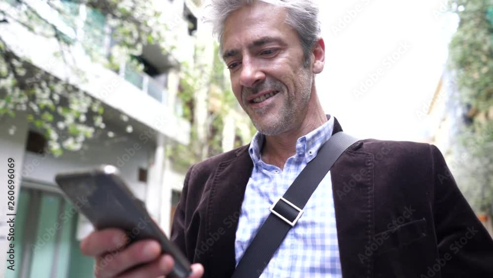 Casual businessman checking cellphone outdoors Casual businessman checking cellphone outdoors