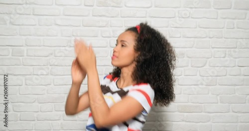 Angry african american woman killing mosquito after bite. Black girl showing rage, anger and frustration for bug flying around her. Upset hispanic person needs repellent for summer insect