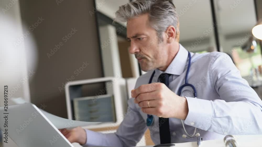 Doctor working in contemporary office Doctor working in contemporary office