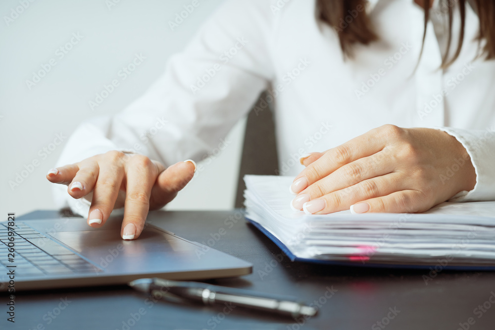 Woman working at office hand on keyboard close up