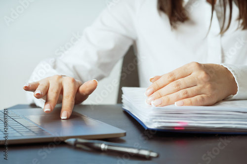 Woman working at office hand on keyboard close up