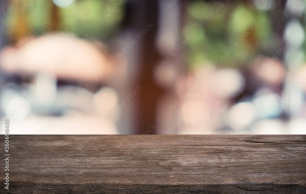 Empty dark wooden table in front of abstract blurred bokeh background of restaurant . can be used for display or montage your products.Mock up for space. Empty dark wooden table in front of abstract blurred bokeh background of restaurant . can be used for display or montage your products.Mock up for space.