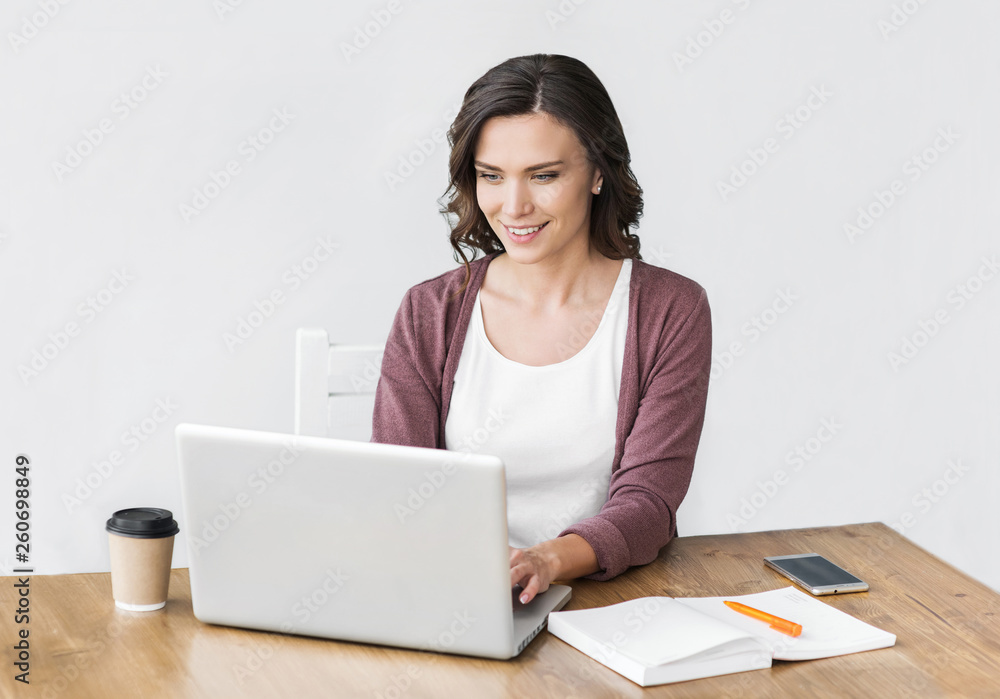 Woman using laptop in office. Young beautiful girl working on computer. Entrepreneur, businesswoman, freelance worker, student typing on keyboard Woman using laptop in office. Young beautiful girl working on computer. Entrepreneur, businesswoman, freelance worker, student typing on keyboard