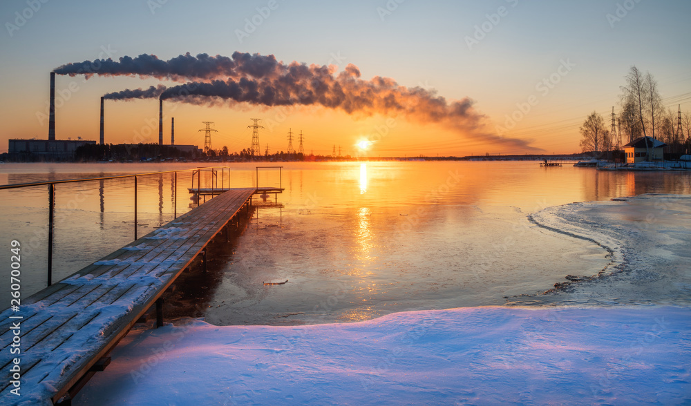 Peftinskiy, Russia - March, 2018: Long exposure shot of the view of the hydropower plant from the shore of the lake in the spring morning