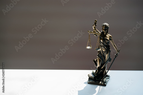 Statue of blind goddess Themis on blurred background