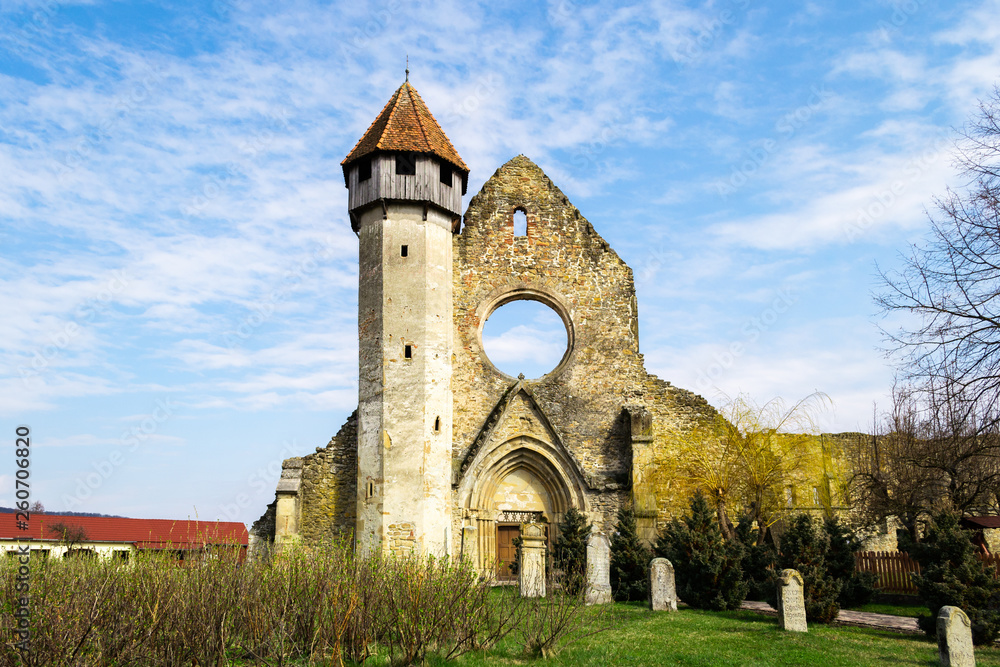 Dramatic church ruins with a few tombstones in front. Carta monastery is a former Cistercian (Benedictine) monastery, located in southern Transylvania, near Sibiu, Romania.