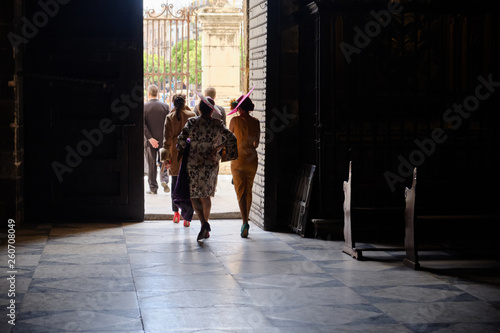 elegant traditional woman dress - peoples exiting from a church after ceremony - Seville Spain. © Alessandro