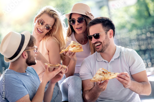 Group of friends eat pizza