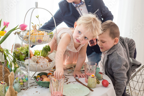 Bilde på lerret Polish children misbehaving, making a mess at Easter family table