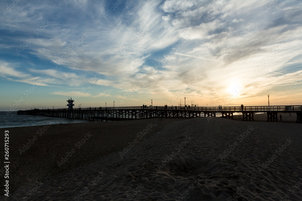 Sunset over an ocean pier on the west coast
