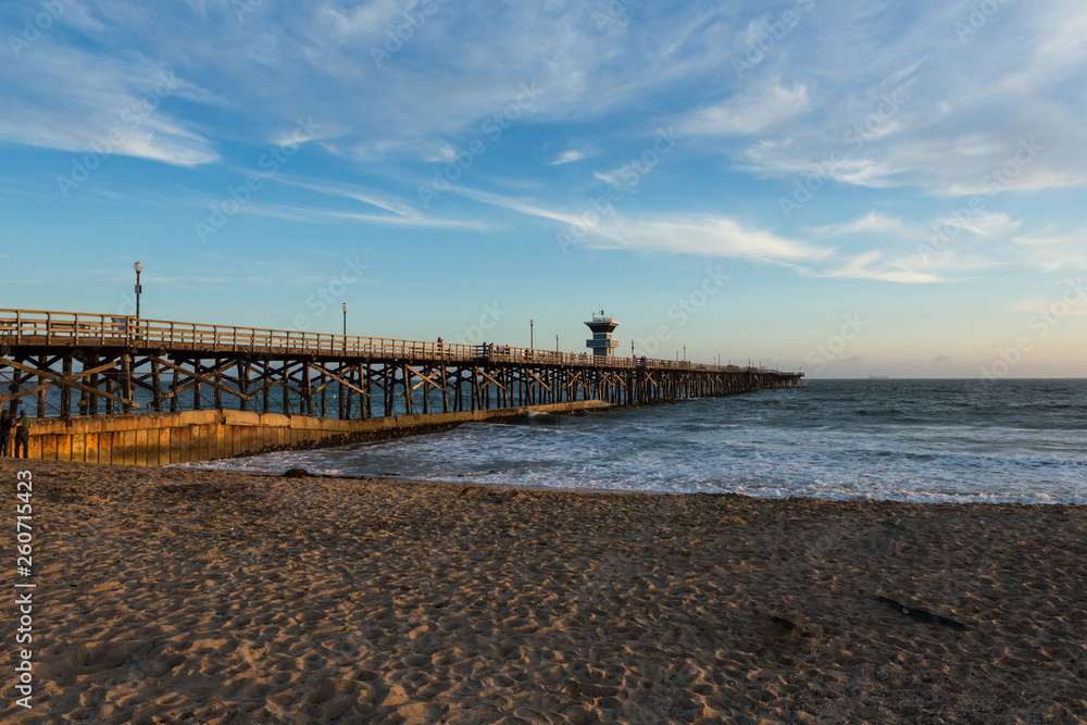 Sunset over an ocean pier on the west coast