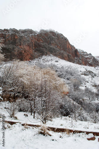 mountains under the snow, landscape with red rocks