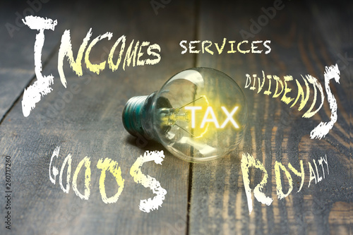 Tax. As a bulb lightens its light, taxes are imposed on goods and services transactions, business income, interest, dividends, interest, rent. photo