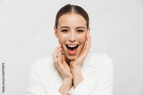 Photo of charming businesswoman 20s wearing elegant jacket screaming and rejoicing at camera