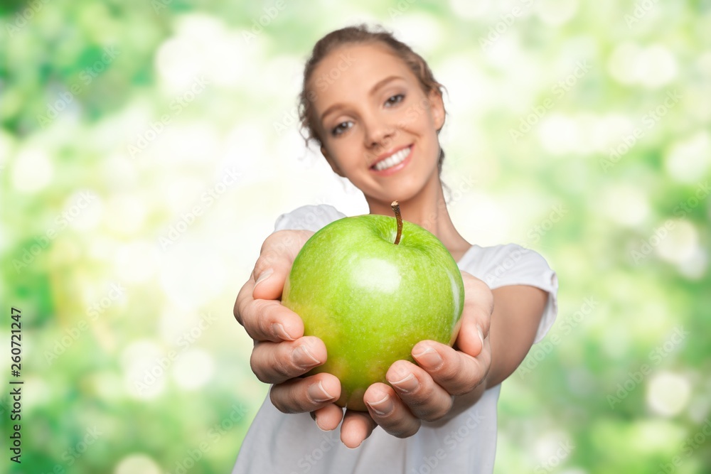 Woman holding two apples isolated on background Woman holding two apples isolated on background