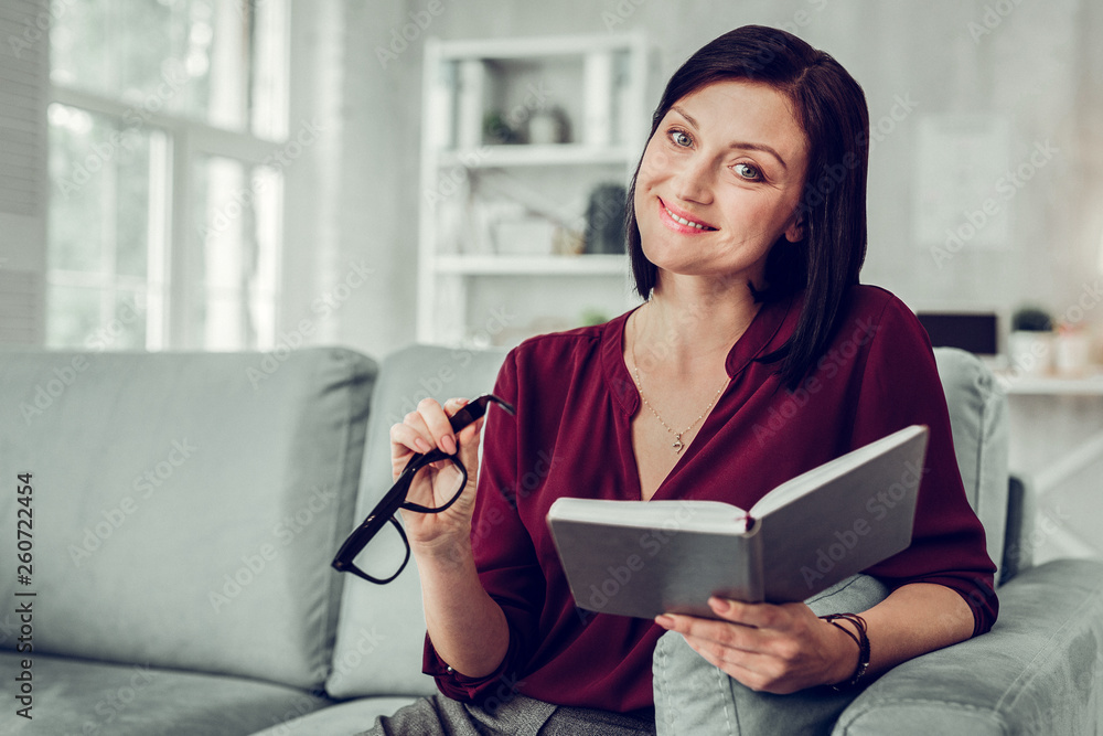 Pleasant family therapist wearing dark red blouse smiling broadly Pleasant family therapist wearing dark red blouse smiling broadly
