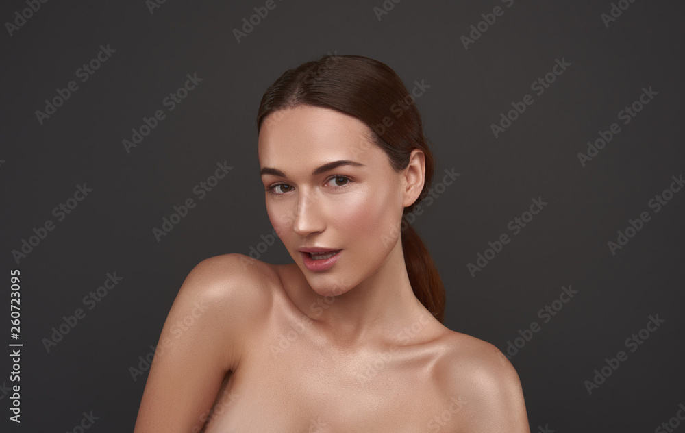 Beautiful girl with perfect skin posing against gray background Beautiful girl with perfect skin posing against gray background
