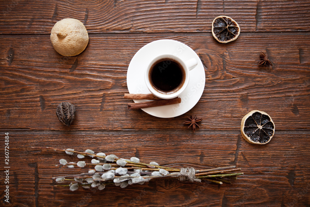 Coffee cup and willow branches, dry lemon, cinnamon. Coffee cup and willow branches, dry lemon, cinnamon.