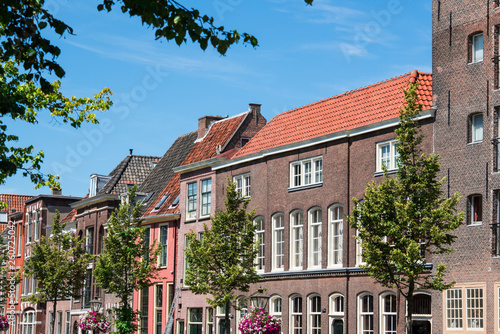 row houses against blue sky in street Oude Rijn in Leiden, The Netherlands