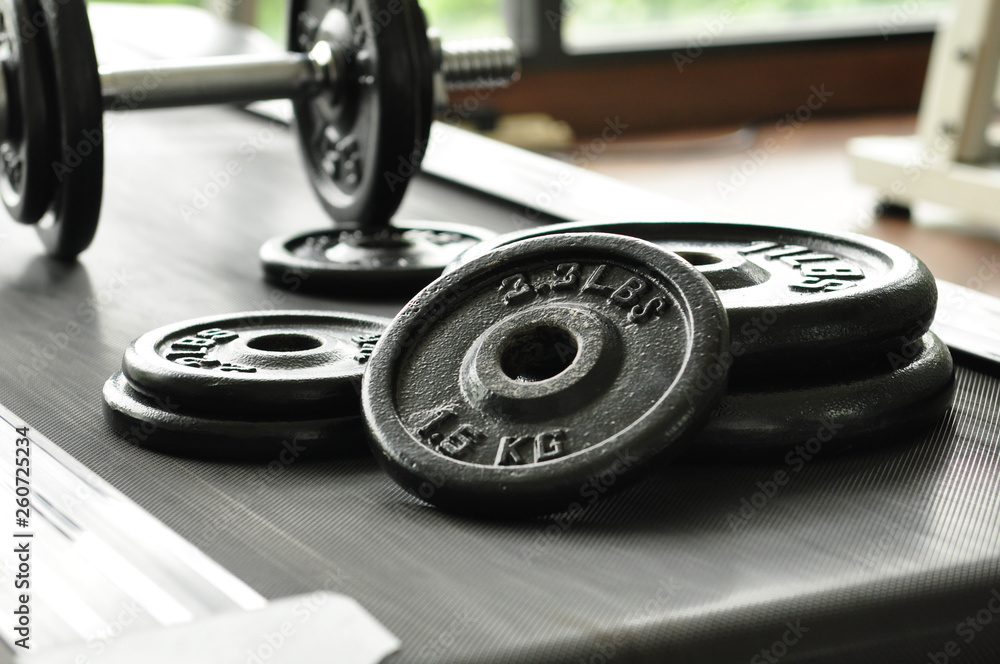 dumbbell and barbell on floor at gym dumbbell and barbell on floor at gym
