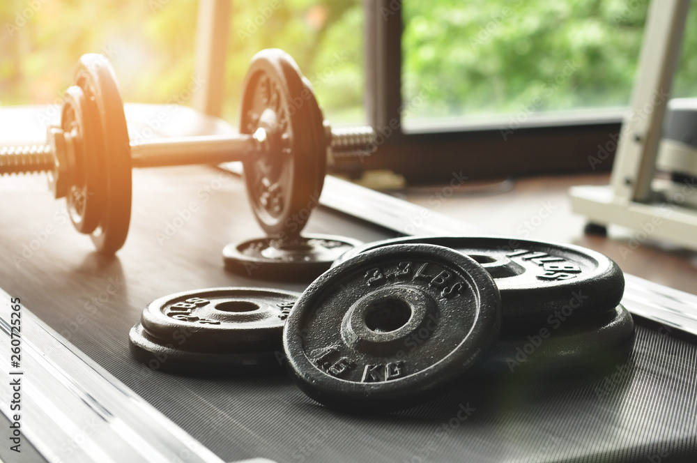 Obraz premium dumbbell and barbell on floor at gym