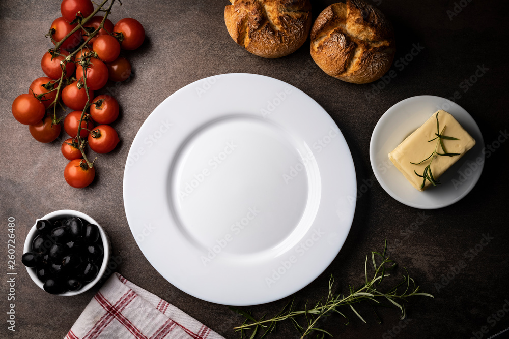 Table setting. White plate and meal ingredients on the table. Table setting. White plate and meal ingredients on the table.