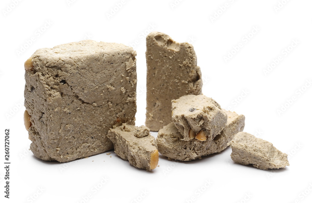 Halvah with raisins and peanuts isolated on white background Halvah with raisins and peanuts isolated on white background