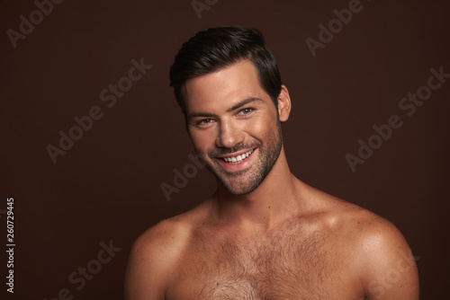 Sexy smiling muscular man with naked torso photo