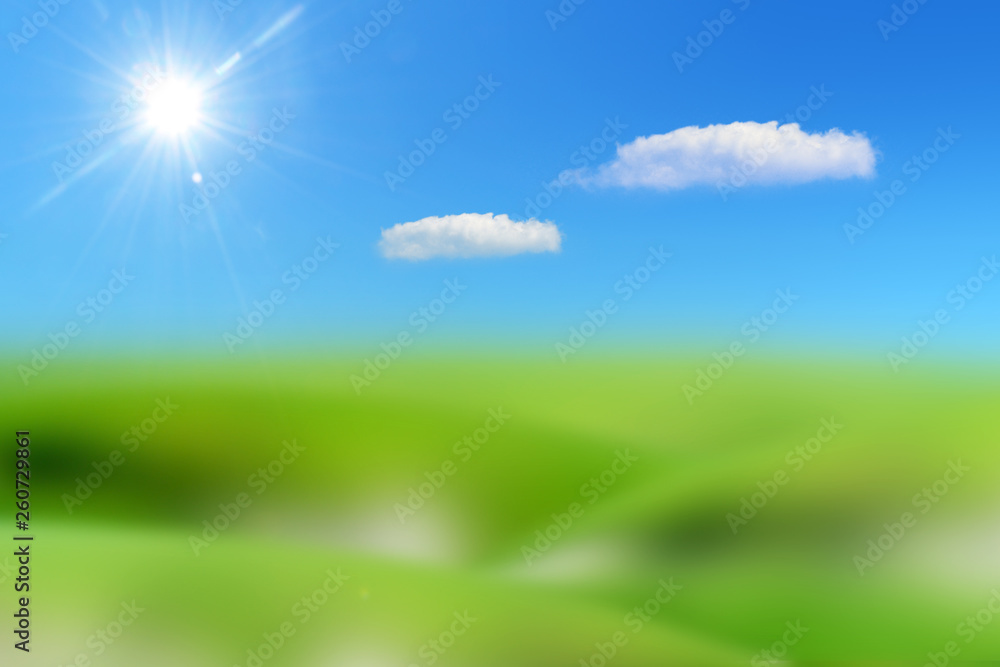 blue sky with sun and clouds on a lawn of green grass