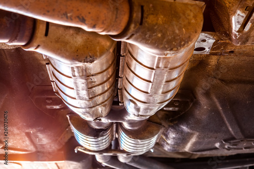 Quadro em tela Extreme closeup of car exhaust pipes underneath the vehicle during repairs in a