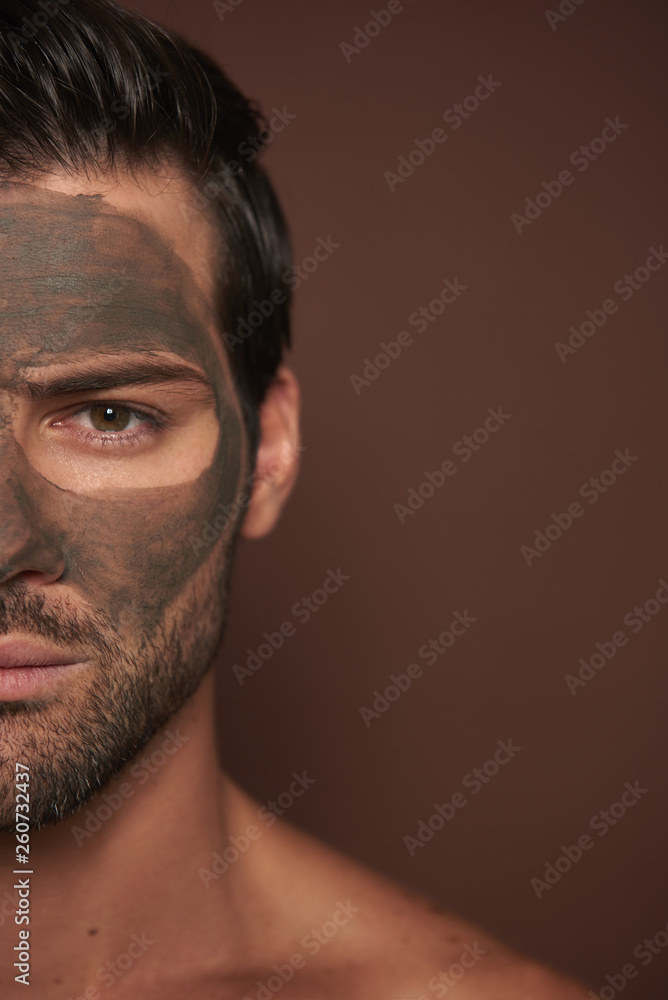 Obraz premium Half face of attractive manful guy with face mask