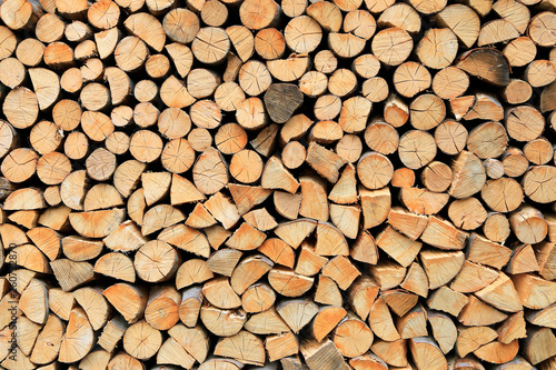 Firewood pile stacked chopped wood trunks