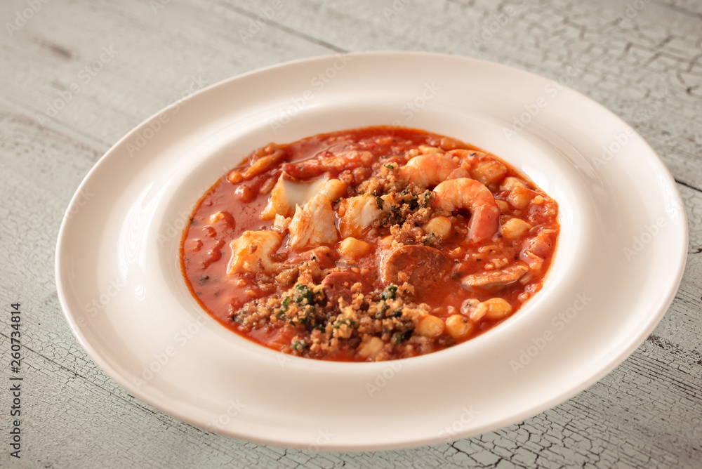 Portion of spanish fish and chorizo soup