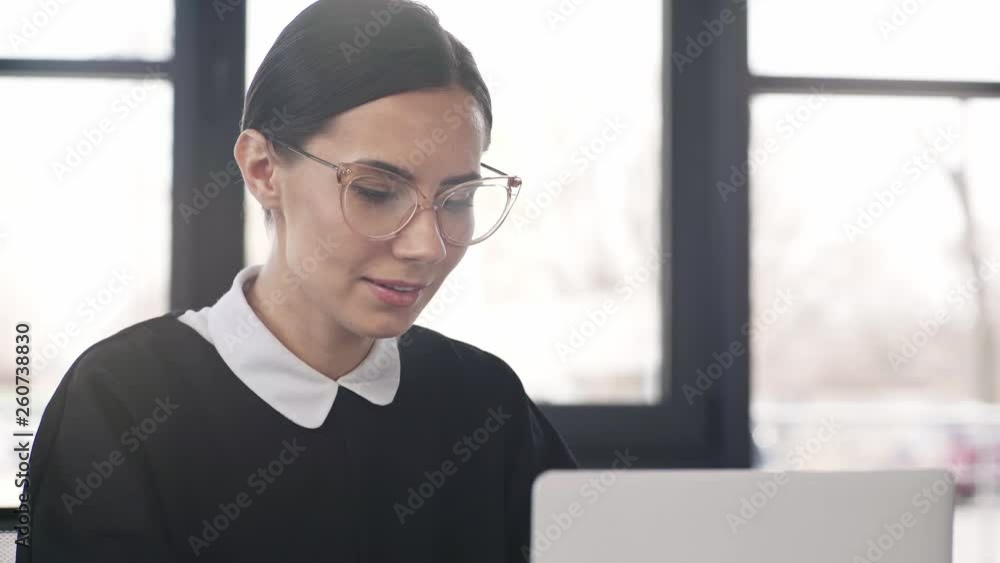 beautiful woman in glasses smiling and looking at camera beautiful woman in glasses smiling and looking at camera