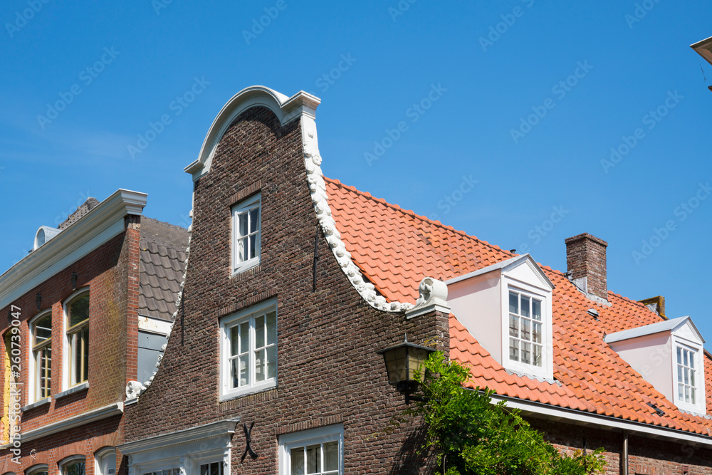 detail Dutch stepped gable house with orange roof tiles in Naarden, The Netherlands