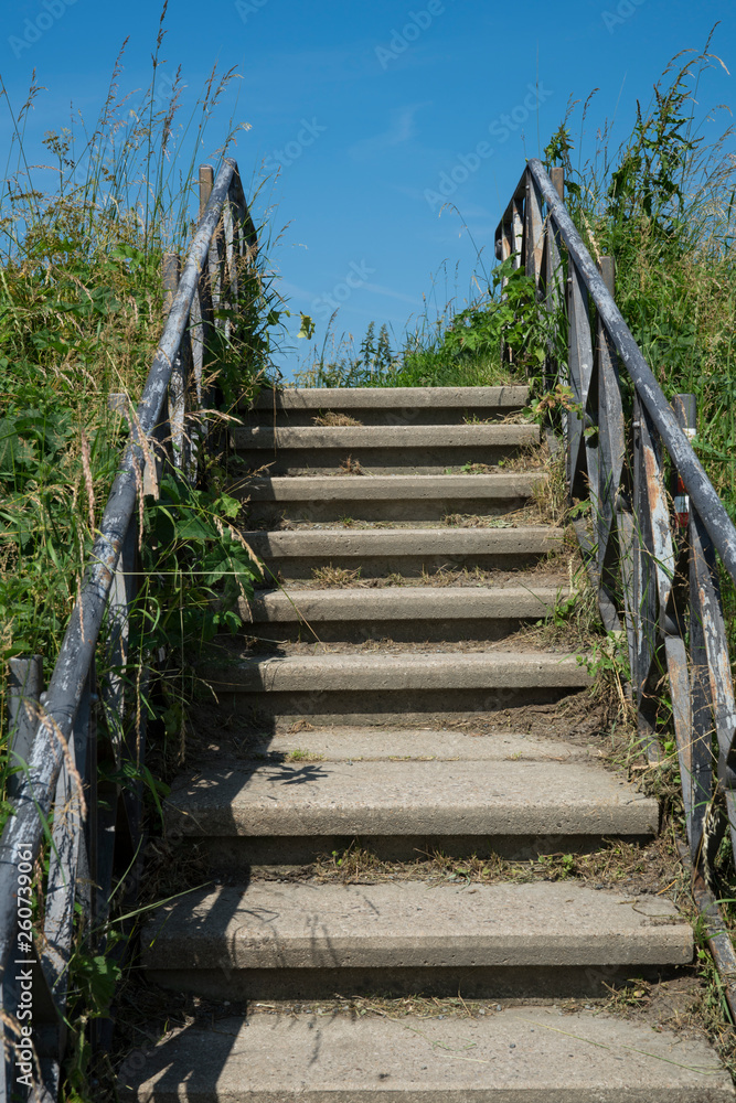 concrete stairs with iron fence, hiking path in Muiden, The Netherlands