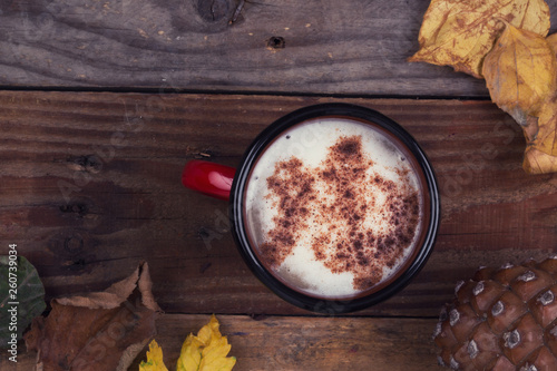 Coffee, dry leaves abd cone on wooden background photo