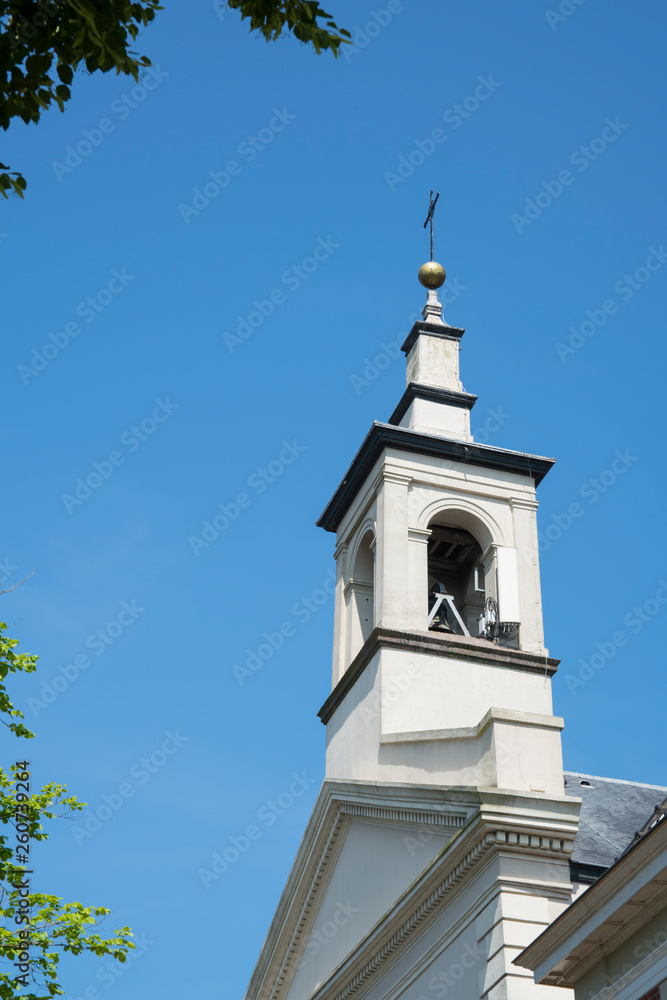 tower of church in fortified village Naarden, The Netherlands. Against blue sky