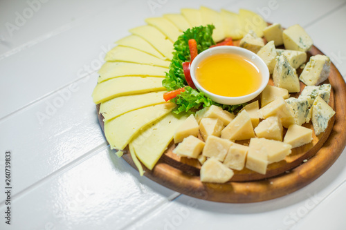 Fototapeta Naklejka Na Ścianę i Meble -  Delicious cheese on the table with honey and vegetables