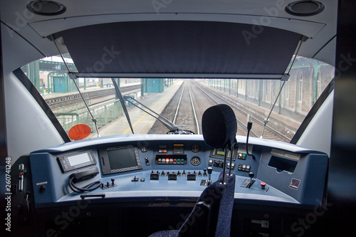 Empty train cabin of driver. Interior of control place of train standing on railway station. Cockpit modern train.