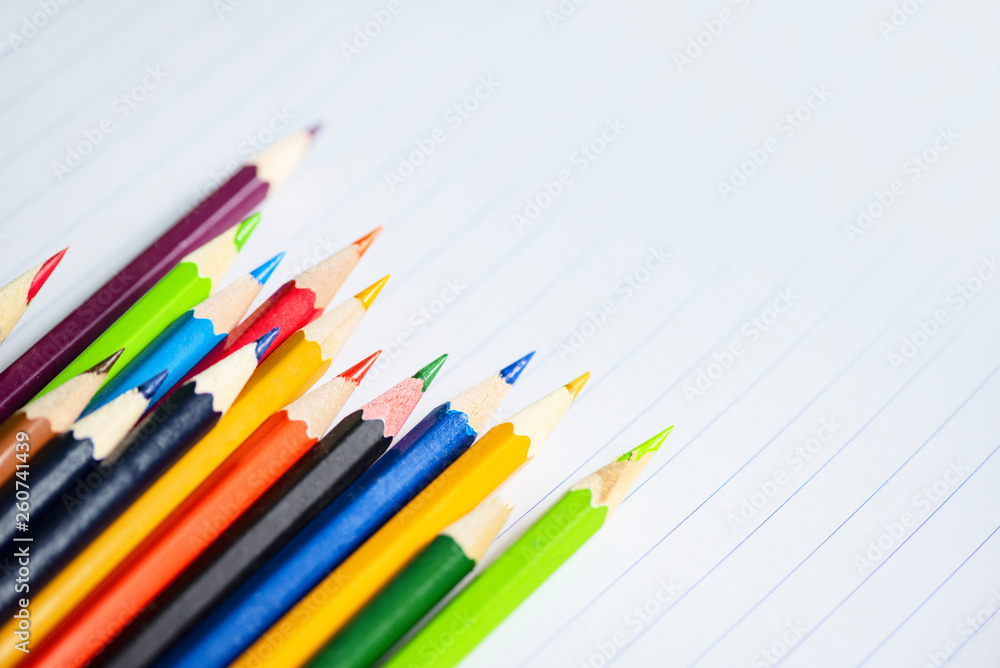 Colored pencil set on white paper notebook back to school and education concept / Crayons colorful Colored pencil set on white paper notebook back to school and education concept / Crayons colorful