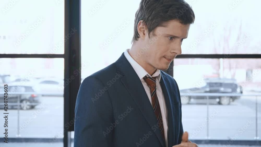 handsome worried man standing and rubbing hands before job interview handsome worried man standing and rubbing hands before job interview