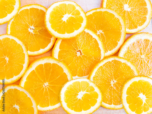 Tableau sur toile Close-up photo of fresh slised orange on a wooden background.