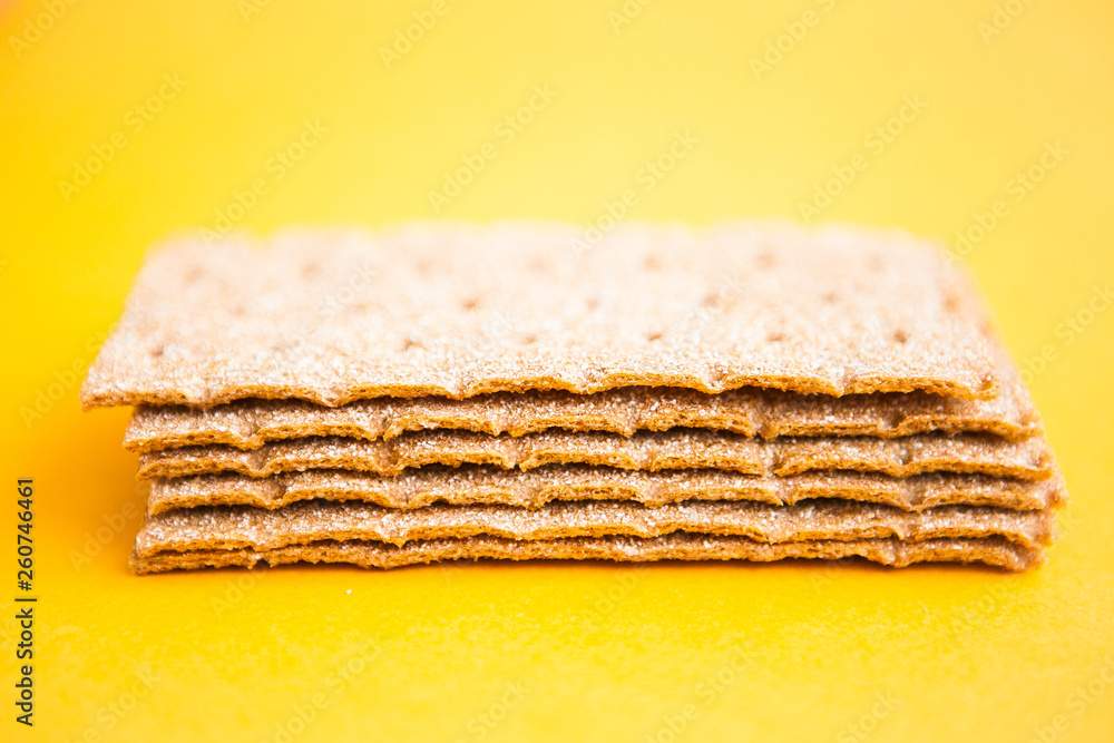 Fototapeta premium Crisp bread on the yellow background