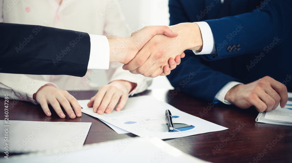 Business people shaking hands finishing up a meeting. Handshake at successful negotiation Business people shaking hands finishing up a meeting. Handshake at successful negotiation