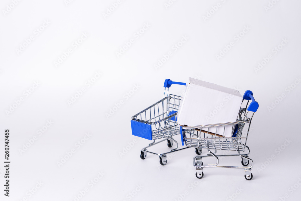 Empty miniature trolley from a supermarket on a white background.