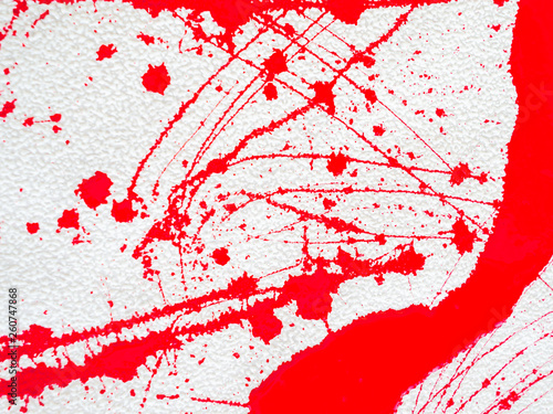 red blot and splatter paint on white background