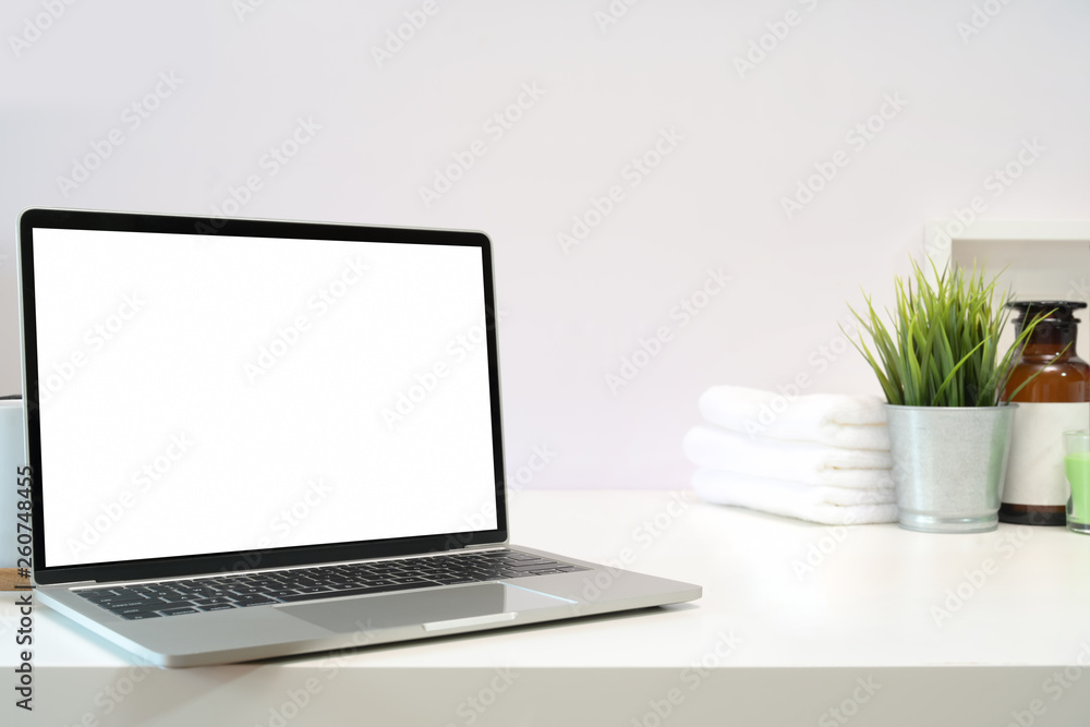 Fototapeta premium Blank screen laptop on spa table