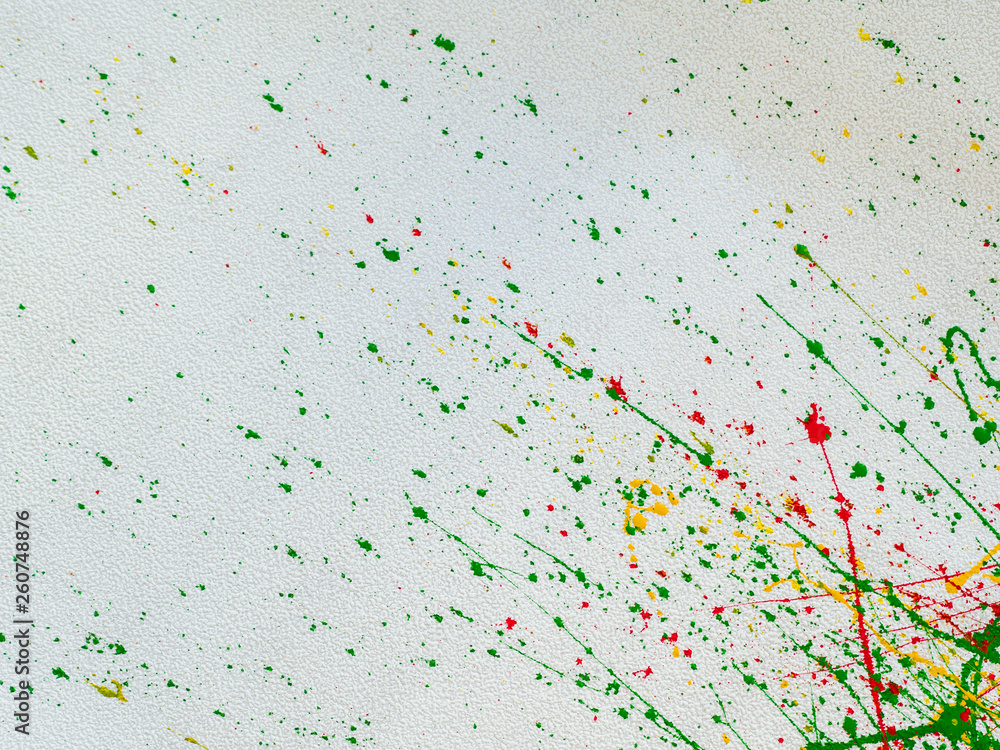 splashes of red and yellow green paint on a white background