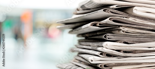 Pile of newspapers on white background